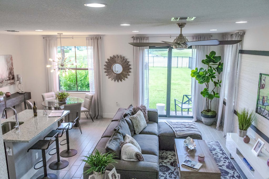 Stylish contemporary living room with open kitchen layout and natural light.