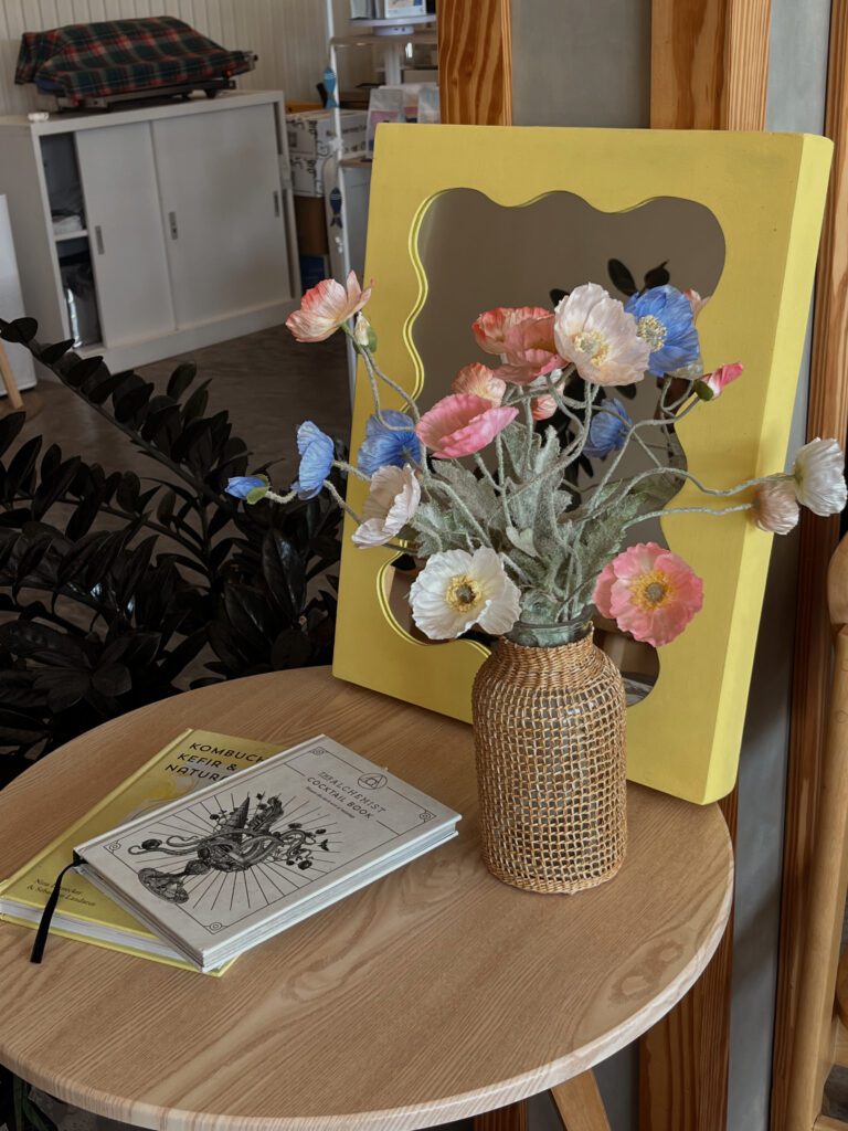 Spring decoration of the living room with flowers and a mirror.