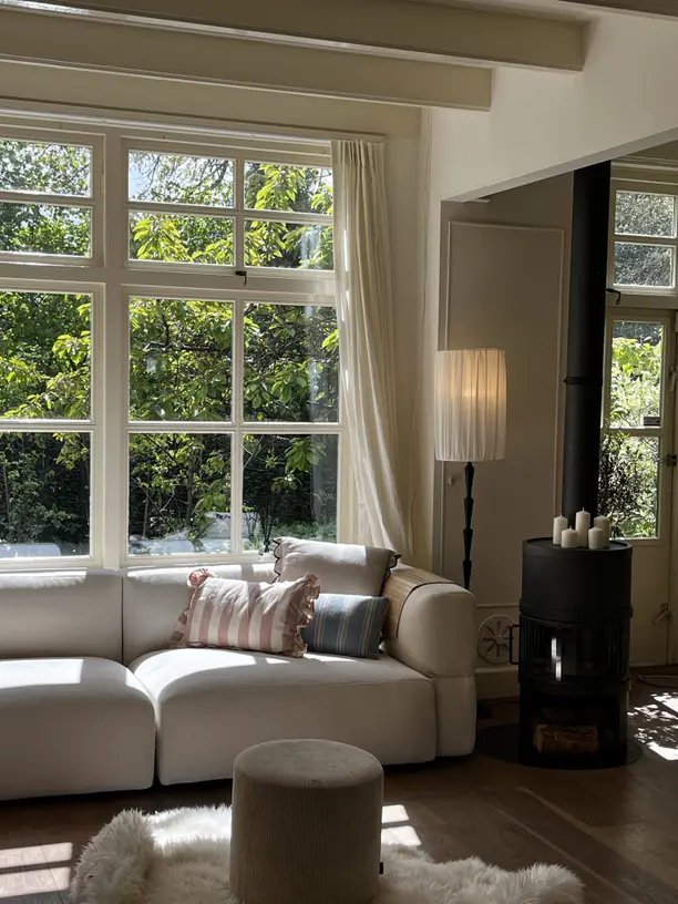 Living room with neutral linen curtains.