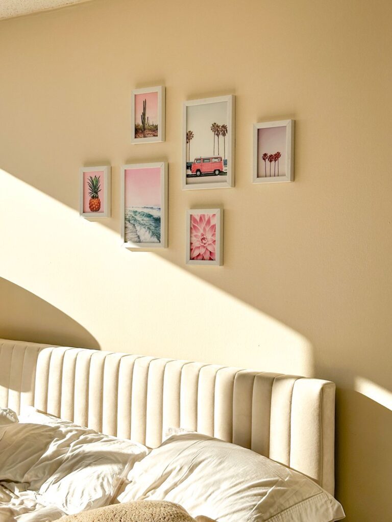 A small bedroom with a wall gallery.